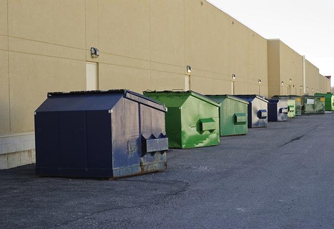 tilted front-load dumpsters being emptied by waste management workers in Cocoa Beach